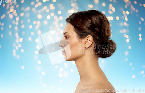 Image of profile of beautiful woman with bare shoulders