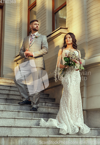 Image of Caucasian romantic young couple celebrating their marriage in city