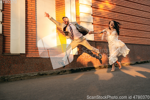 Image of Caucasian romantic young couple celebrating their marriage in city