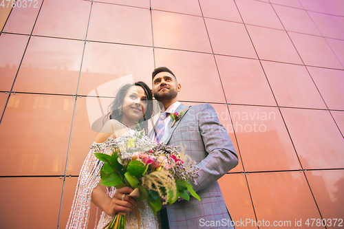 Image of Caucasian romantic young couple celebrating their marriage in city