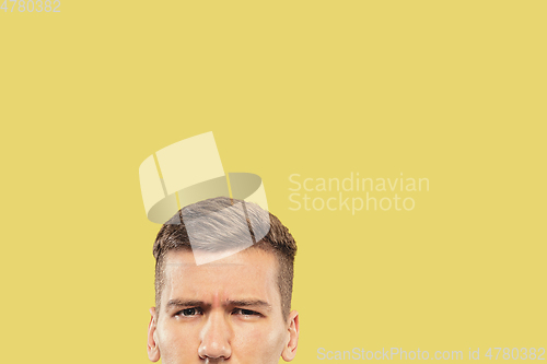 Image of Caucasian young man\'s close up shot on yellow background