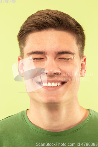 Image of Caucasian young man\'s close up shot on green background