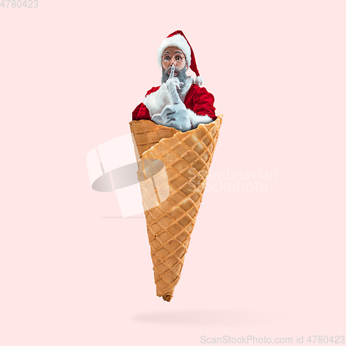 Image of Happy Christmas Santa Claus on coral studio background