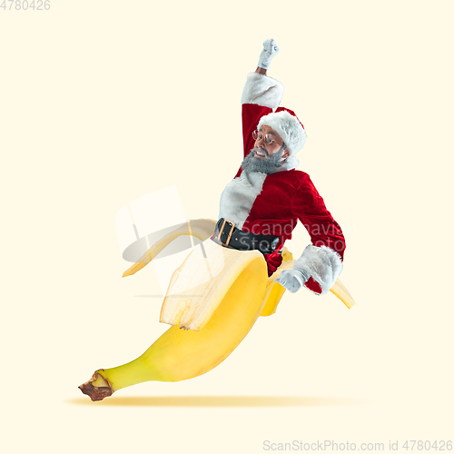 Image of Happy Christmas Santa Claus on yellow studio background