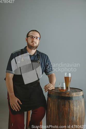 Image of Confident young male brewer with self crafted beer