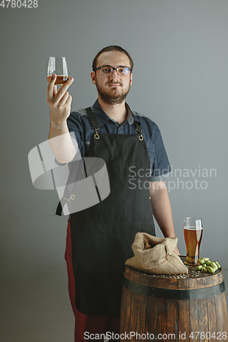 Image of Confident young male brewer with self crafted beer