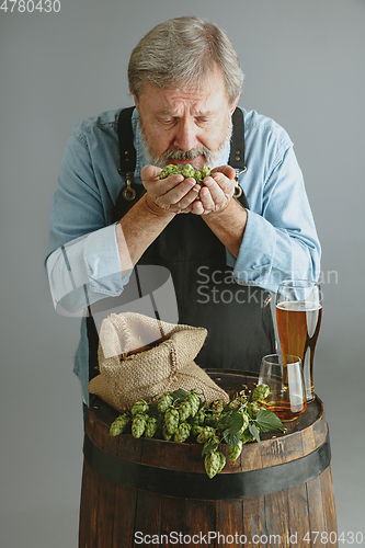 Image of Confident senior man brewer with self crafted beer