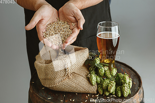 Image of Close up of confident young man brewer with self crafted beer