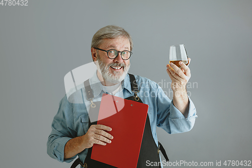 Image of Confident senior man brewer with self crafted beer