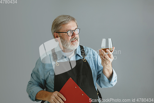 Image of Confident senior man brewer with self crafted beer