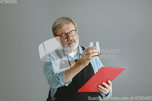 Image of Confident senior man brewer with self crafted beer