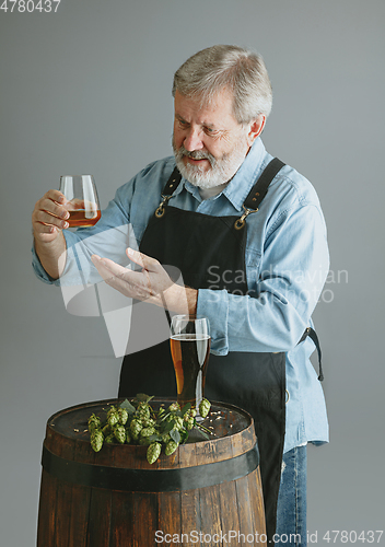 Image of Confident senior man brewer with self crafted beer