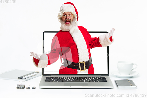 Image of Happy Christmas Santa Claus greeting from the laptop screen on white background