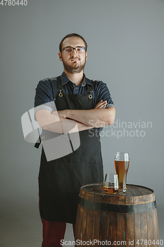 Image of Confident young male brewer with self crafted beer