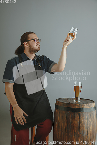 Image of Confident young male brewer with self crafted beer