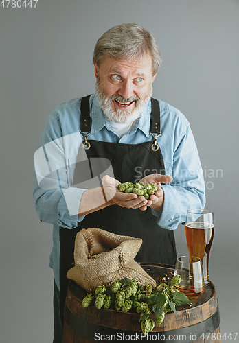 Image of Confident senior man brewer with self crafted beer