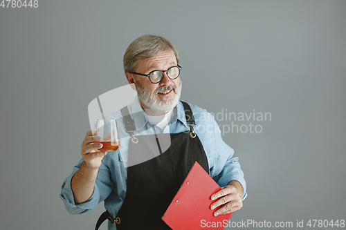 Image of Confident senior man brewer with self crafted beer