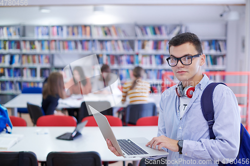 Image of the student uses a notebook, latop and a school library