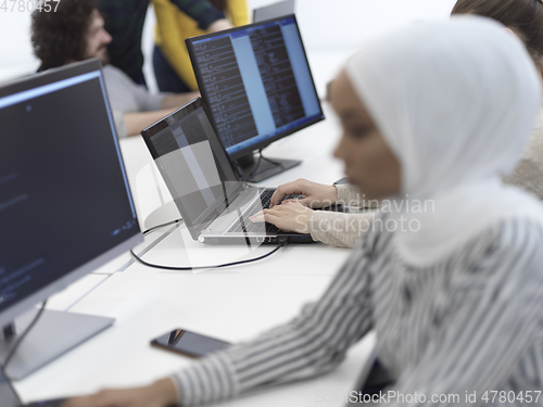 Image of african muslim business woman at office as part of creative team