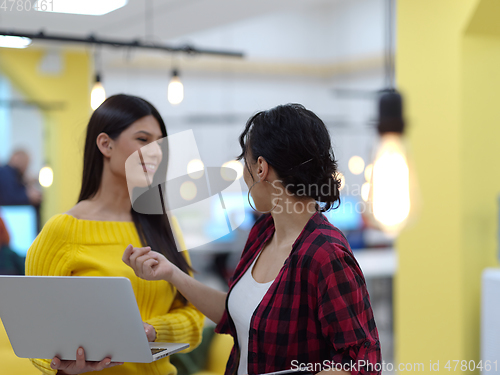 Image of female friends discussion about project at moder coworking office