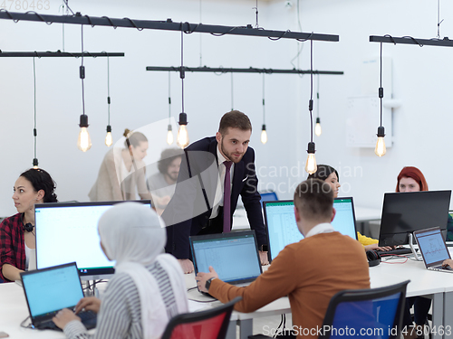 Image of creative business people group as freelancers in modern coworking open space office