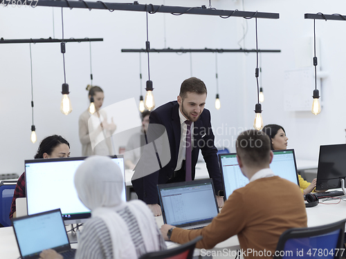 Image of creative business people group as freelancers in modern coworking open space office