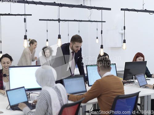 Image of creative business people group as freelancers in modern coworking open space office