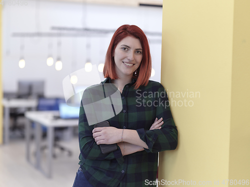 Image of redhead business woman portrait in creative modern coworking startup open space office
