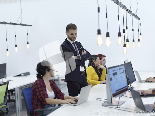 Image of creative business people group as freelancers in modern coworking open space office