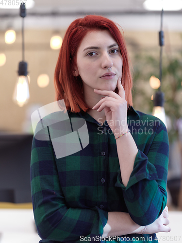 Image of redhead business woman portrait in creative modern coworking startup open space office
