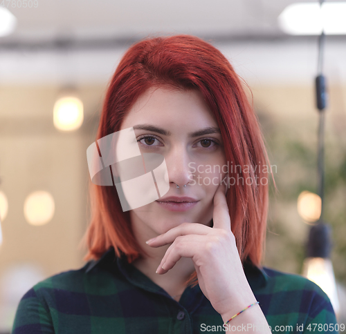 Image of redhead business woman portrait in creative modern coworking startup open space office