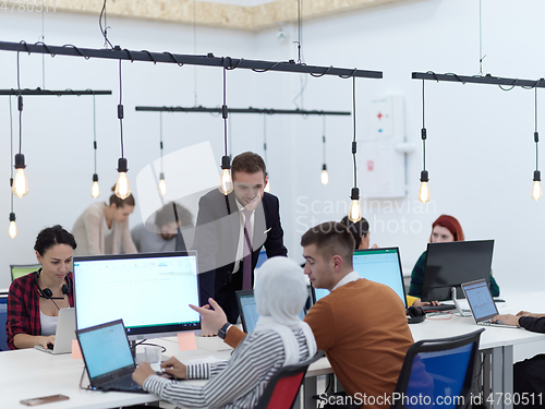 Image of creative business people group as freelancers in modern coworking open space office