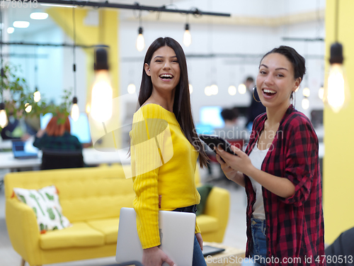 Image of female friends discussion about project at moder coworking office