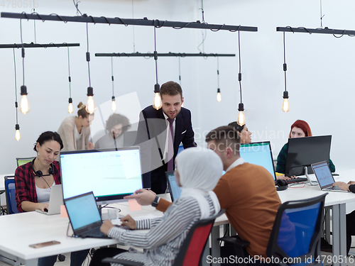 Image of creative business people group as freelancers in modern coworking open space office
