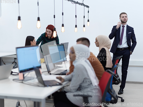 Image of creative business people group as freelancers in modern coworking open space office