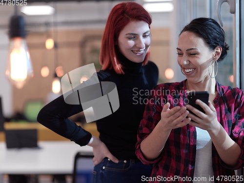 Image of female friends discussion about project at moder coworking office