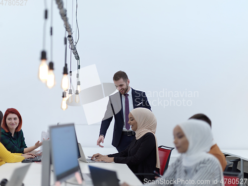 Image of creative business people group as freelancers in modern coworking open space office