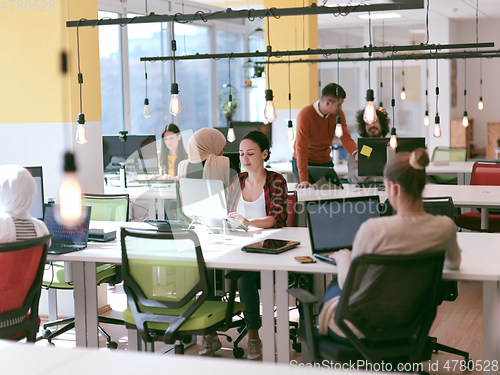 Image of creative business people group as freelancers in modern coworking open space office