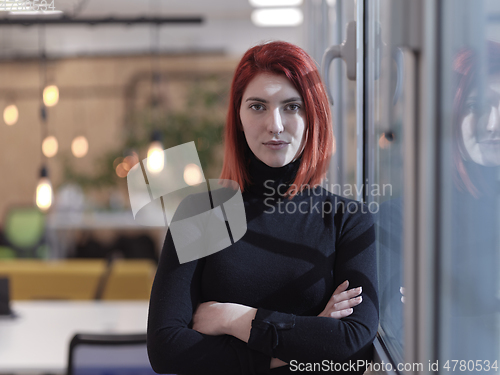 Image of redhead business woman portrait in creative modern coworking startup open space office