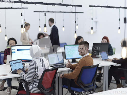 Image of creative business people group as freelancers in modern coworking open space office