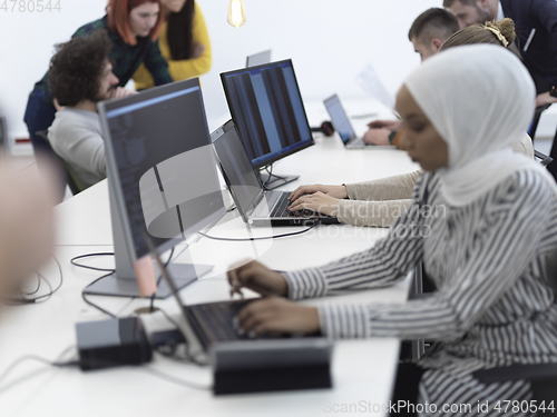 Image of african muslim business woman at office as part of creative team