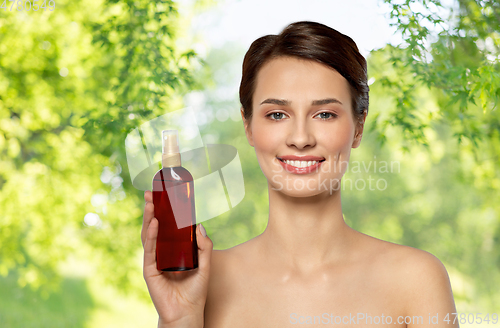 Image of beautiful young woman with sun protective oil