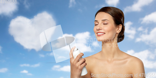 Image of beautiful young woman with facial spray or mist