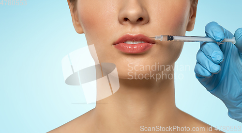 Image of beautiful young woman and hand with syringe