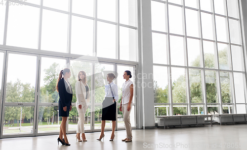 Image of businesswomen meeting at office and talking