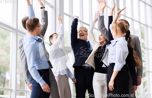 Image of business people celebrating success at office