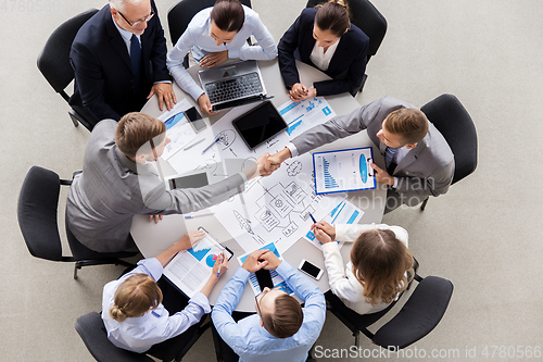 Image of businessmen making handshake at office