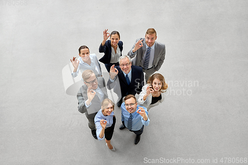 Image of business people showing ok hand sign at office