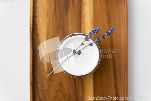 Image of close up of lavender moisturizer on wooden tray