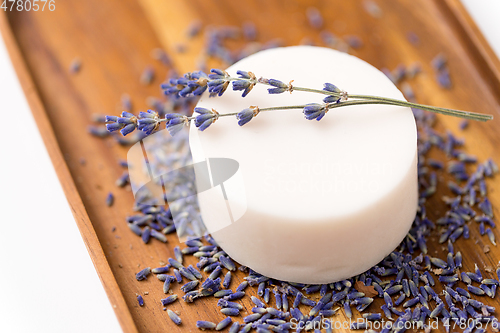 Image of close up of crafted lavender soap on wooden tray